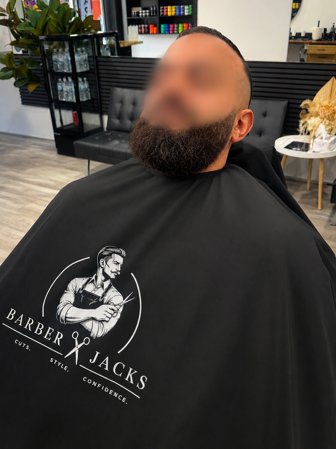 Client in a Barber Jacks branded cape after a beard service, Gunnedah