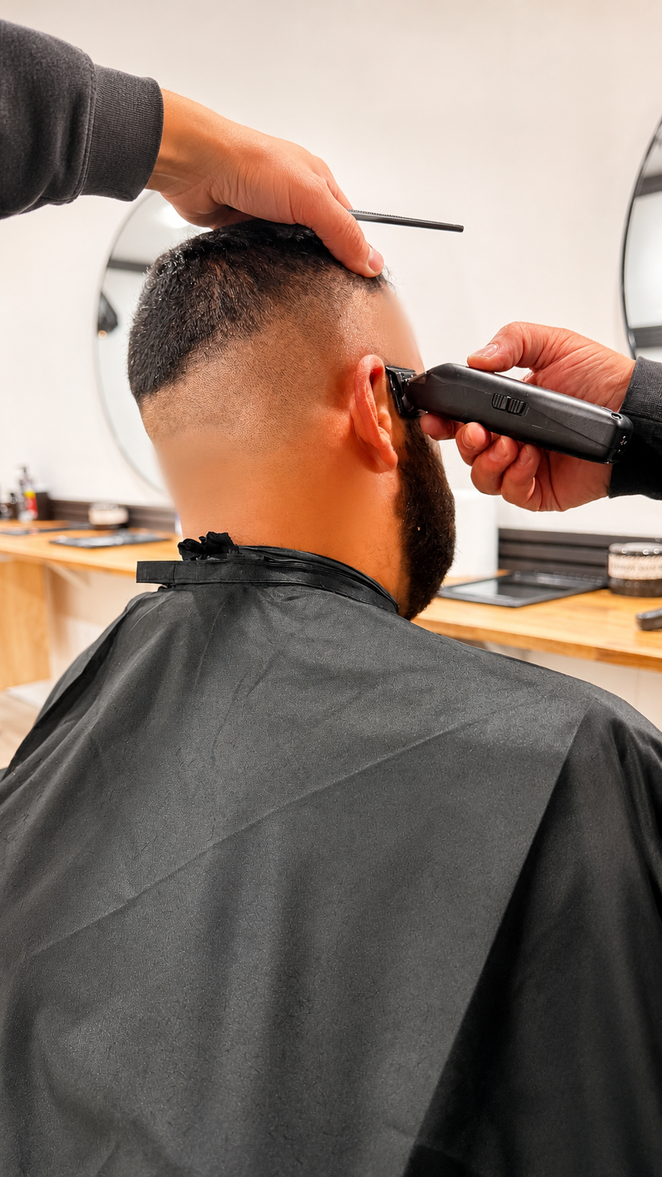 Barber using clippers to fade a client's neckline at Barber Jacks, Gunnedah